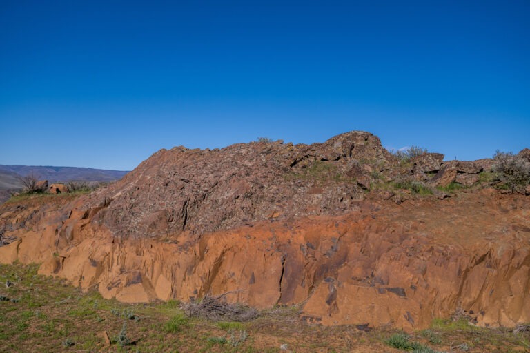 Rust-colored basalt outcrop and sagebrush at The Perch above the Columbia River near Quincy, Washington