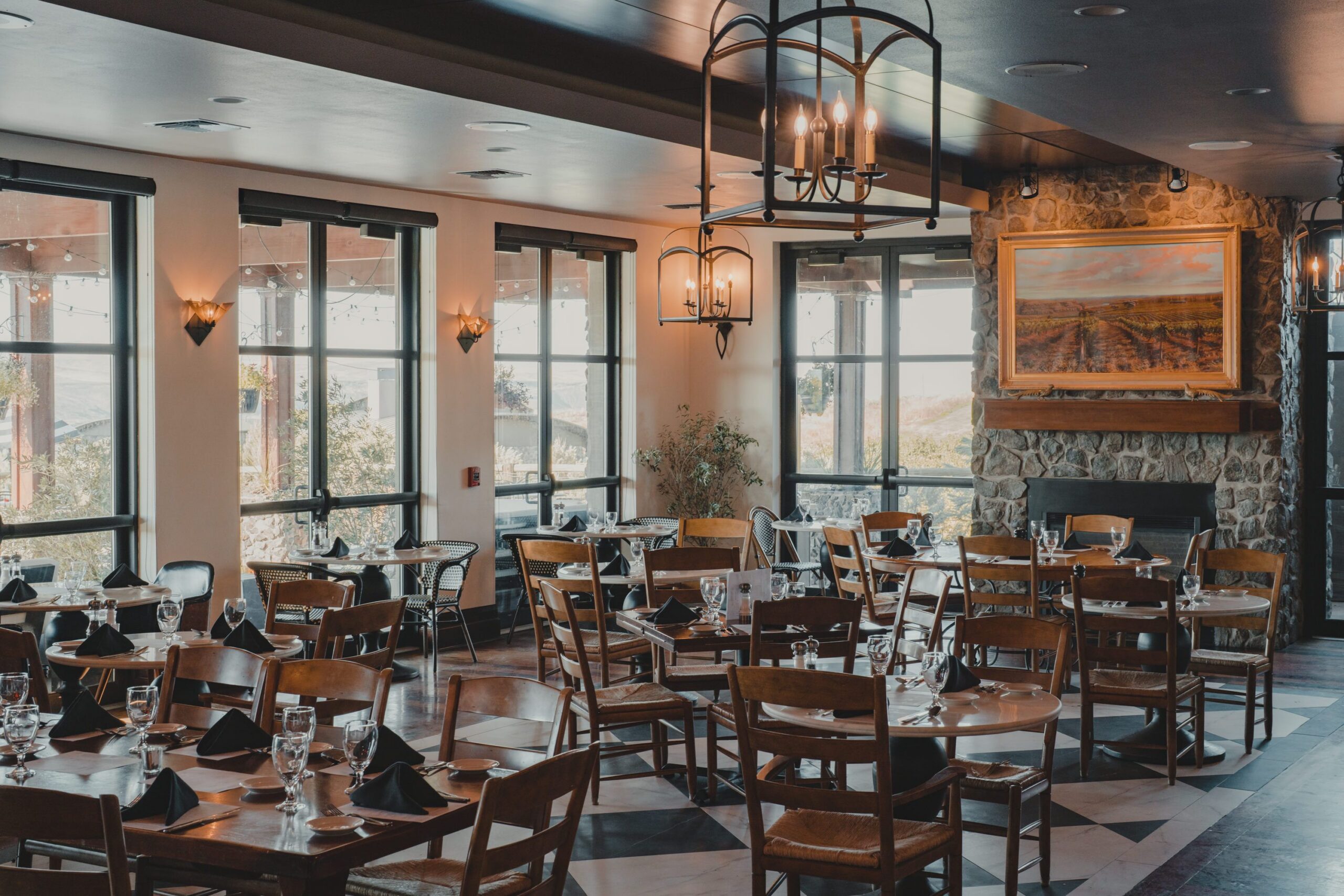 Dining room at Tendrils Restaurant, Sagecliffe, with stone fireplace and lantern chandeliers